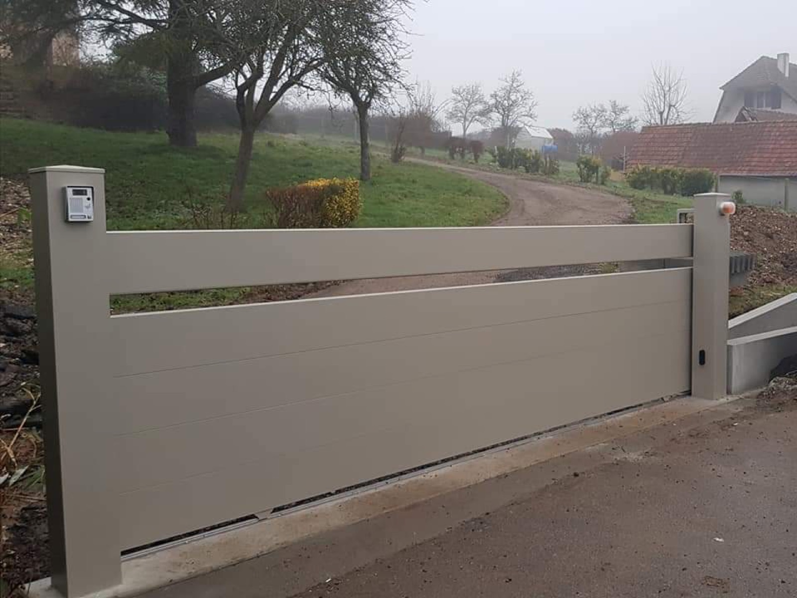 Portail aluminium coulissant taupe sur propriété rurale en Seine-Maritime — réalisation Dagicour