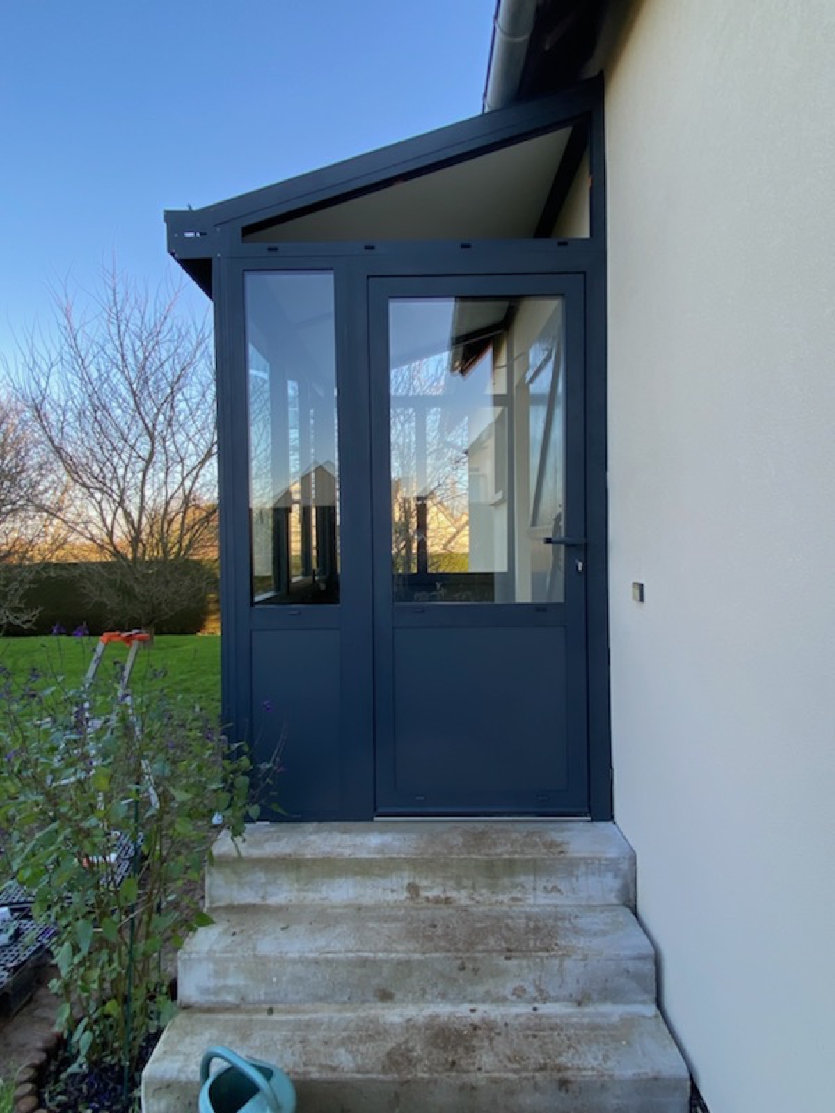 Porte d'entrée vitrée aluminium anthracite intégrée à un sas d'entrée, avec perron en béton — Dagicour Seine-Maritime